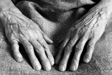 Working wrinkled hands of an old woman.