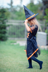 Happy girl in halloween costume with jack pumpkin.Trick or treat