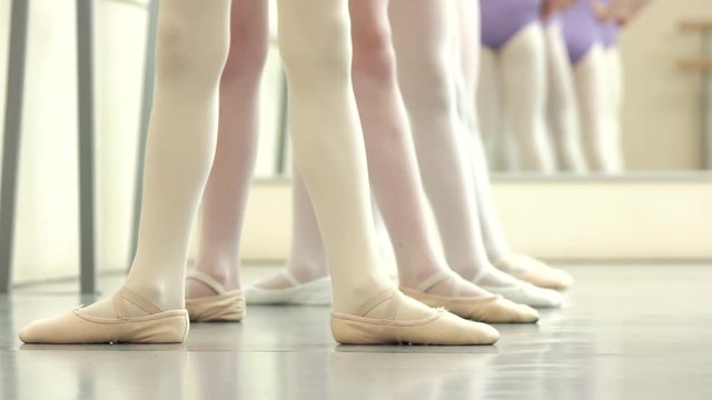 Ballet dancers background. Ballerina legs first position in pointe. Classic ballet position.