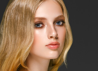 Blonde woman face closeup with healthy skin and beauty makeup