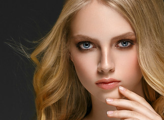 Blonde woman face closeup with healthy skin and beauty makeup