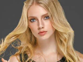 Blonde woman face closeup with healthy skin and beauty makeup