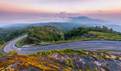 Beautiful super curve road on top of mountain with mist fog background during sunset time at doi inthanon chiang mai thailand