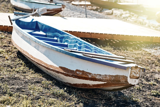 An old boat lies on the shore.
