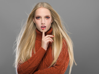 Woman in knitted sweater fashion with blonde long hair autumn stylish
