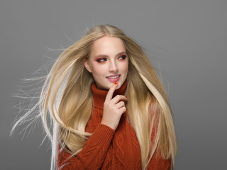 Woman in knitted sweater fashion with blonde long hair autumn stylish