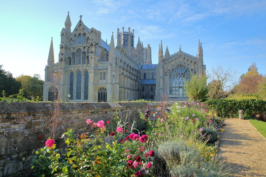 View of The Eastern part of the Cathedral from a public garden with colorful flowers in the foreground, Ely, Cambridgeshire, Norfolk, UK
