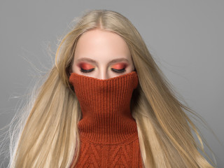 Woman in knitted sweater fashion with blonde long hair autumn stylish