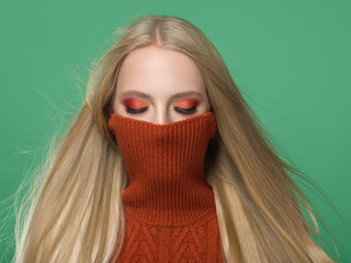 Woman in knitted sweater fashion with blonde long hair autumn stylish