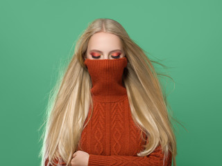 Woman in knitted sweater fashion with blonde long hair autumn stylish