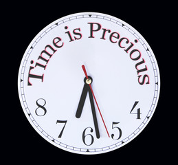 Fototapeta na wymiar Time is PRECIOUS use is wisely - white clock face with the words TIME IS PRECIOUS printed around the top half replacing the numerals against a black background 