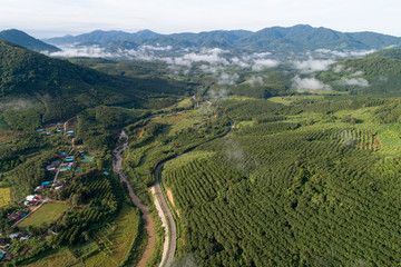 Fototapeta na wymiar Aerial view country village with mountain and mist fog during morning time in asia thailand
