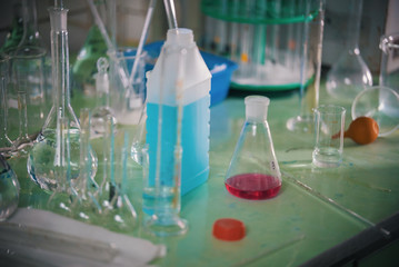 Table full of chemicals and flasks. Chemical lab