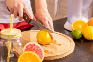 Woman cutting lemon on a cutting board
