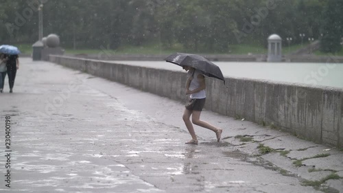 Sad Girl With An Umbrella Walking In The Rain Outdoors