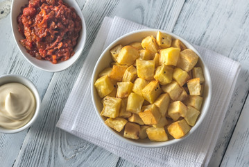 Portion of patatas bravas with sauces