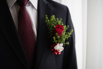 boutonniere of roses on a jacket, wedding day