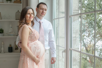 Fototapeta premium Pregnant couple. Man bonding his pregnant woman