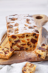 Traditional Christmas cake with fruits and nuts on white table