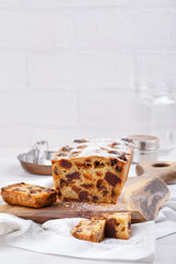 Traditional Christmas cake with fruits and nuts on white table