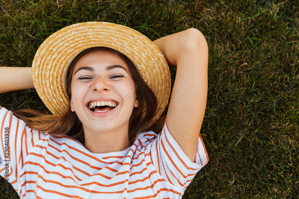 Sticker top view of a laughing young girl in summer hat