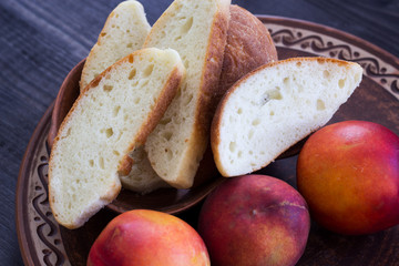 Homemade bread and fruit on a dark background. Close-up. Top view