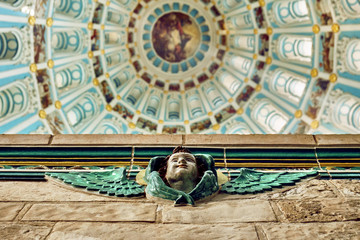 Sculpture of an angel with the Dome interior of the Ressurection Cathedral of the russian New Jerusalem monastery on the background