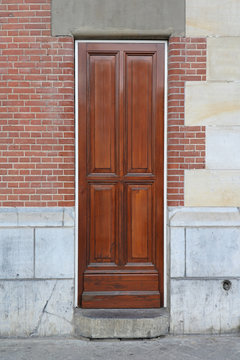 Retro Narrow Wooden Door With Brick Wall Facade