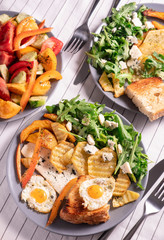 fried eggs and salad for breakfast, close-up, top view