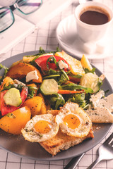 Life style breakfast, fried eggs and salad, coffee, book and glasses