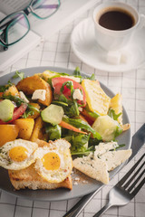 Life style breakfast, fried eggs and salad, coffee, book and glasses