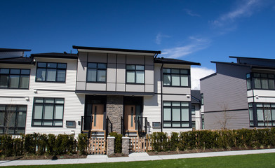 External facade of a row of colorful modern urban townhouses.brand new houses just after...