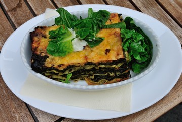 Vegan lasanga made with spinach and served with green salad