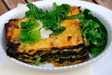 Vegan lasanga made with spinach and served with green salad