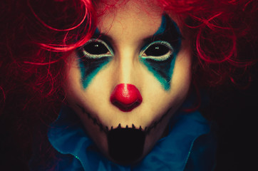 Creepy clown close up halloween portrait on black background