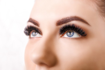 Eyelash Extension Procedure. Woman Eye with Long Eyelashes. Close up, selective focus. Hollywood, russian volume - 230405377