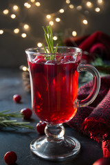 Christmas cranberry and apple mulled wine garnish rosemary and fir branches on black. Xmas drink.