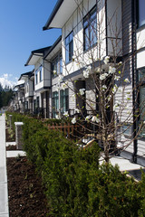 Residential townhouses on blue sky background on sunny day. External facade of a row of colorful modern urban townhouses.brand new houses just after construction on real estate market