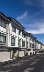 A row of a new townhouses. External facade of a row of colorful modern urban townhouses.brand new houses just after construction on real estate market