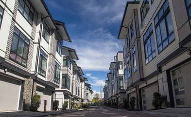 Rows of townhomes side by side. External facade of a row of colorful modern urban townhouses. brand...