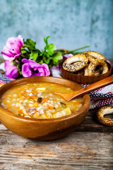 Pickle soup on old wooden table.