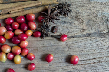 cup of coffee with cinnamon and anise stars on a dark wooden background,top view