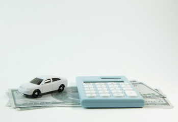 white car toy and blue calculator white background..