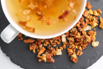 Still life, aromatic dry tea with fruits and petals