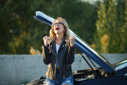 Image Of Frustrated Woman In Glasses Near Broken Car With Open Hood