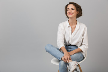Business woman posing isolated over grey wall