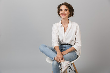 Business woman posing isolated over grey wall