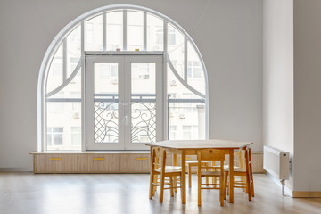 wooden table with chairs in light minimalistic kindergarten room