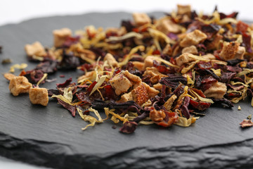 Still life, aromatic dry tea with fruits and petals