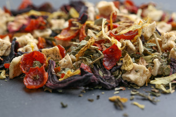 Still life, aromatic dry tea with fruits and petals